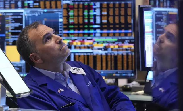 Trader Christopher Lagana is reflected in one of his monitors as he works on the floor of the New York Stock Exchange, Thursday, Nov. 7, 2024. (AP Photo/Richard Drew)