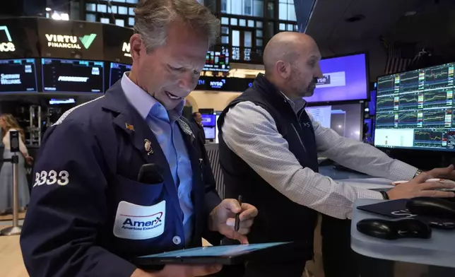 Trader Robert Chamak, left, and specialist James Denaro work on the floor of the New York Stock Exchange, Monday, Nov. 4, 2024. (AP Photo/Richard Drew)