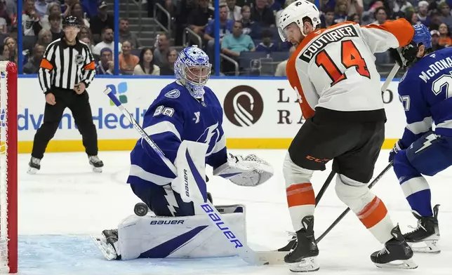 Tampa Bay Lightning goaltender Andrei Vasilevskiy (88) stops a shot by Philadelphia Flyers center Sean Couturier (14) during the third period of an NHL hockey game Thursday, Nov. 7, 2024, in Tampa, Fla. (AP Photo/Chris O'Meara)