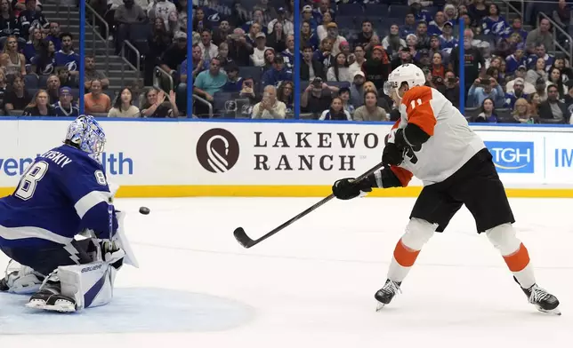 Philadelphia Flyers right wing Travis Konecny (11) scores past Tampa Bay Lightning goaltender Andrei Vasilevskiy (88) during a shootout in an NHL hockey game Thursday, Nov. 7, 2024, in Tampa, Fla. (AP Photo/Chris O'Meara)