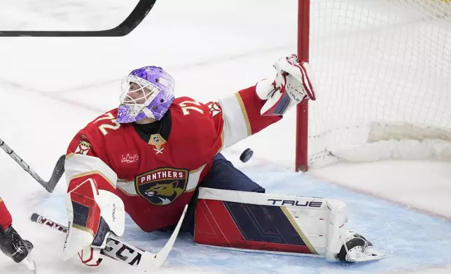 Florida Panthers goaltender Sergei Bobrovsky deflects a shot during the first period of an NHL hockey game against the Philadelphia Flyers, Saturday, Nov. 9, 2024, in Sunrise, Fla. (AP Photo/Wilfredo Lee)