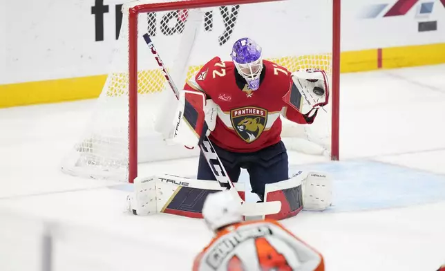 Florida Panthers goaltender Sergei Bobrovsky (72) makes a save against Philadelphia Flyers center Sean Couturier (14) during the second period of an NHL hockey game, Saturday, Nov. 9, 2024, in Sunrise, Fla. (AP Photo/Wilfredo Lee)