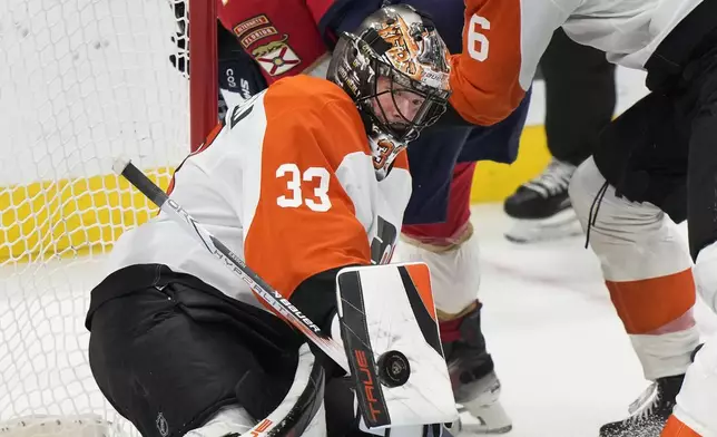 Philadelphia Flyers goaltender Samuel Ersson (33) blocks a shot during the first period of an NHL hockey game against the Florida Panthers, Saturday, Nov. 9, 2024, in Sunrise, Fla. (AP Photo/Wilfredo Lee)