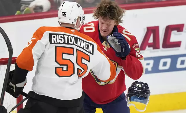 Philadelphia Flyers defenseman Rasmus Ristolainen (55) knocks the helmet off of Florida Panthers center Jesper Boqvist (70) during the first period of an NHL hockey game, Saturday, Nov. 9, 2024, in Sunrise, Fla. (AP Photo/Wilfredo Lee)