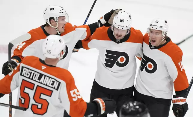 Philadelphia Flyers left wing Joel Farabee, second from right, celebrates with teammates after he scored during the first period of an NHL hockey game against the Florida Panthers, Saturday, Nov. 9, 2024, in Sunrise, Fla. (AP Photo/Wilfredo Lee)