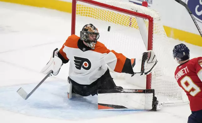 Florida Panthers center Sam Bennett, right, scores against Philadelphia Flyers goaltender Samuel Ersson during the second period of an NHL hockey game, Saturday, Nov. 9, 2024, in Sunrise, Fla. (AP Photo/Wilfredo Lee)