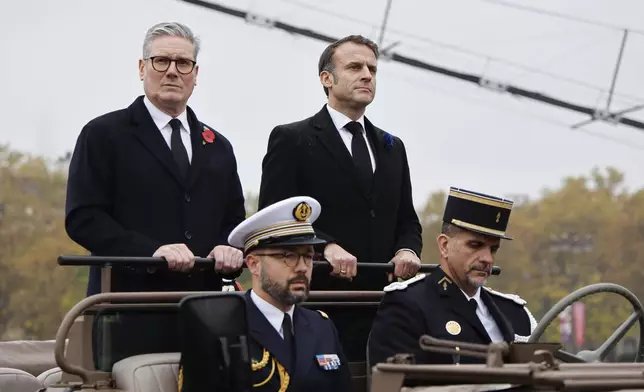 French President Emmanuel Macron, right, and Britain's Prime Minister Keir Starmer look on upon their arrival on the Place de l'Etoile to attend commemorations marking the 106th anniversary of the November 11, 1918, Armistice, ending World War I, in Paris, Monday, Nov. 11, 2024. ( Ludovic Marin, Pool via AP)