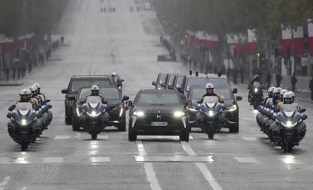 The motorcade carrying French President Emmanuel Macron and British Prime Minister Keir Starmer drive up the Champs Elysees avenue Monday, Nov. 11, 2024 in Paris, during ceremonies marking the 106th anniversary of the Armistice, a celebration of their countries' friendship, as nations across the world pay tribute to their fallen soldiers in World War I. (AP Photo/Michel Euler, Pool)