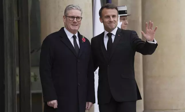 French President Emmanuel Macron, right, gestures with British Prime Minister Keir Starmer Monday, Nov. 11, 2024 at the Elysee Palace in Paris, before ceremonies marking the 106th anniversary of the Armistice, a celebration of their countries' friendship, as nations across the world pay tribute to their fallen soldiers in World War I. (AP Photo/Aurelien Morissard)