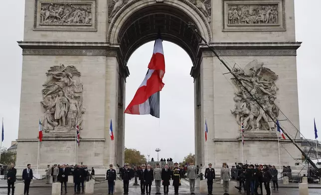 French President Emmanuel Macron, center right, French Chief of Staff of the Armed Forces Thierry Burkhard, center, and Britain's Prime Minister Keir Starmer stand at attention as Republican Guards parade by the Arc de Triomphe during commemorations marking the 106th anniversary of the November 11, 1918, Armistice, ending World War I, in Paris, Monday, Nov. 11, 2024. ( Ludovic Marin, Pool via AP)