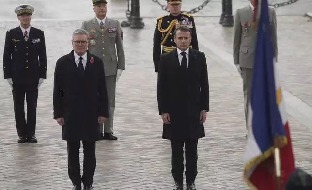 French President Emmanuel Macron and British Prime Minister Keir Starmer, left, attend ceremonies marking the 106th anniversary of the Armistice, a celebration of their countries' friendship, as nations across the world pay tribute to their fallen soldiers in World War I, Monday, Nov. 11, 2024 in Paris, (AP Photo/Michel Euler, Pool)