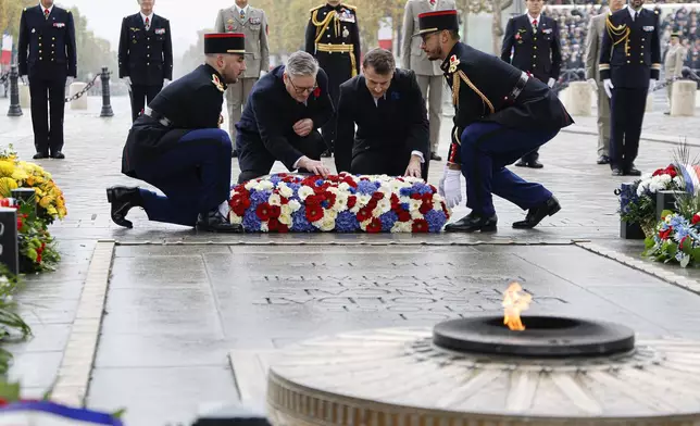 French President Emmanuel Macron, center right, and Britain's Prime Minister Keir Starmer lay a wreath at the Tomb of the Unknown Soldier during commemorations marking the 106th anniversary of the November 11, 1918, Armistice, ending World War I, in Paris, Monday, Nov. 11, 2024. ( Ludovic Marin, Pool via AP)