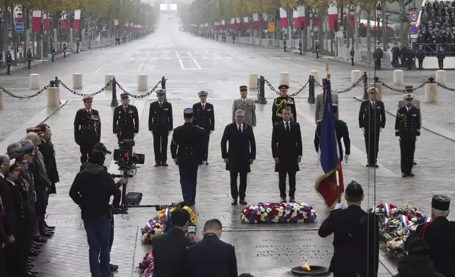 French President Emmanuel Macron, center right, and British Prime Minister Keir Starmer, center left, attend ceremonies marking the 106th anniversary of the Armistice, a celebration of their countries' friendship, as nations across the world pay tribute to their fallen soldiers in World War I, Monday, Nov. 11, 2024 at the Arc de Triomphe in Paris, (AP Photo/Michel Euler, Pool)