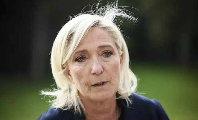 FILE - French far-right leader Marine Le Pen answers reporters at the Elysee Palace after a meeting with French President Emmanuel Macron, Aug. 26, 2024 in Paris. (AP Photo/Thomas Padilla, File)