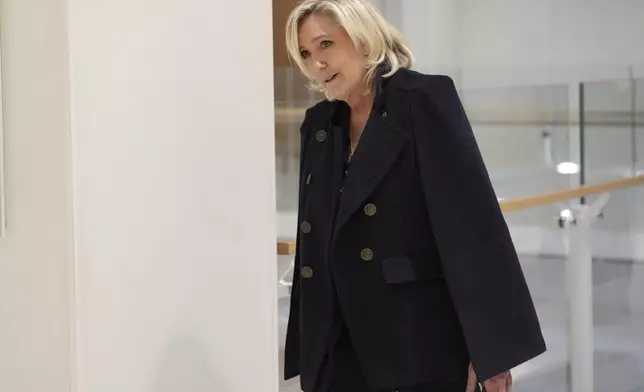 FILE - French far-right leader Marine Le Pen arrives at the courtroom for the trial over the suspected embezzlement of European Parliament funds, Wednesday, Nov. 6, 2024 in Paris. (AP Photo/Aurelien Morissard, File)