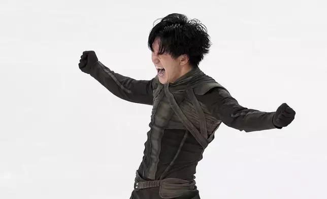 Adam Siao Him Fa, of France, reacts after competing in the men's free skating segment at the ISU Grand Prix of Figure Skating, Saturday, Nov. 2, 2024, in Angers, France. (AP Photo/Aurelien Morissard)