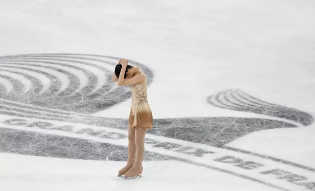 Chaeyeon Kim, of South Korea, reacts after competing in the women's free skating segment at the ISU Grand Prix of Figure Skating, Saturday, Nov. 2, 2024, in Angers, France. (AP Photo/Aurelien Morissard)