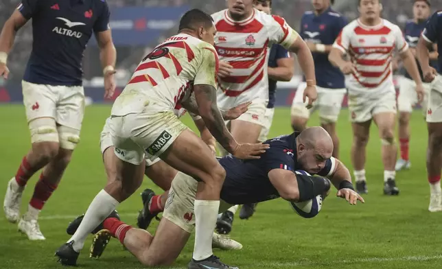 France's Jean-Baptiste Gros goes over to score a try during the Autumn Nations series rugby union match between France and Japan at the Stade de France in Saint-Denis, outside Paris, Saturday, Nov. 9, 2024. (AP Photo/Christophe Ena)