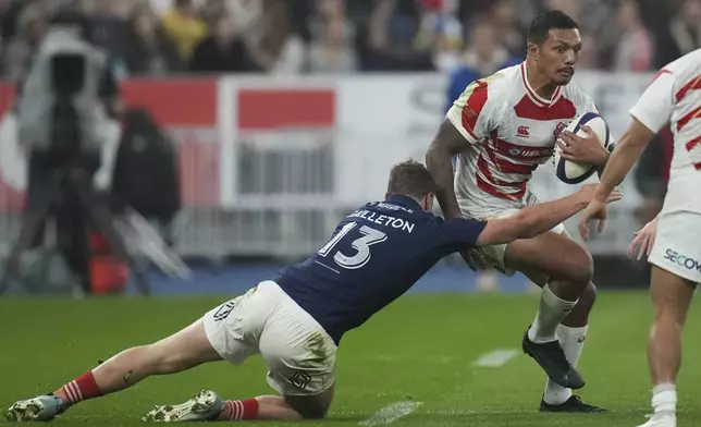 Japan's Malo Tuitama is tackled by France's Emilien Gailleton during the Autumn Nations series rugby union match between France and Japan at the Stade de France in Saint-Denis, outside Paris, Saturday, Nov. 9, 2024. (AP Photo/Christophe Ena)