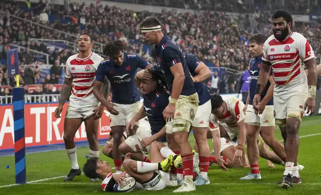 France's Paul Boudehent, center, scores a try during the Autumn Nations series rugby union match between France and Japan at the Stade de France in Saint-Denis, outside Paris, Saturday, Nov. 9, 2024. (AP Photo/Christophe Ena)