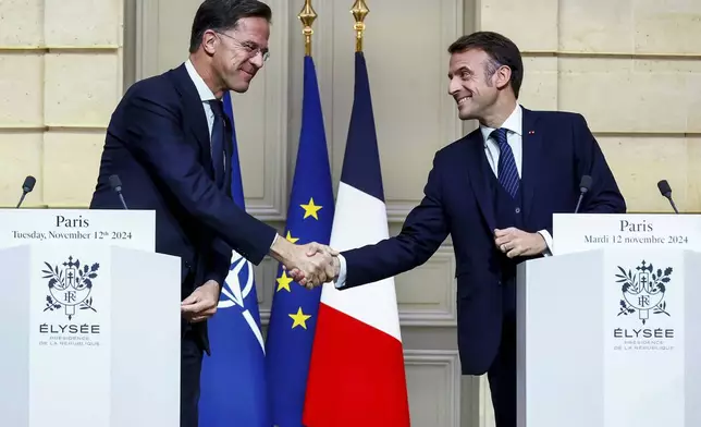 French President Emmanuel Macron and NATO Secretary General Mark Rutte shake hands during their meeting at the Elysee Palace, in Paris, France, Tuesday, Nov. 12, 2024. (Manon Cruz/ Pool Photo via AP)