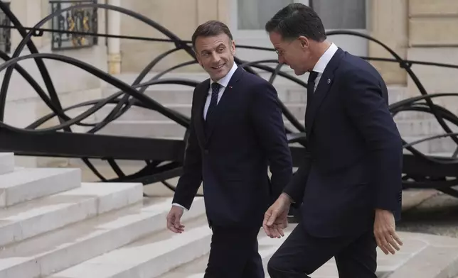 France's President Emmanuel Macron, left, welcomes NATO Secretary General Mark Rutte prior to a meeting at the Elysee Palace, in Paris, France, Tuesday, Nov. 12, 2024. (AP Photo/Michel Euler)