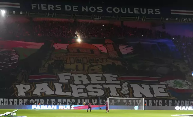 A giant banner reads "Free Palestine" is seen before the Champions League opening phase soccer match between Paris Saint Germain and Atletico Madrid at the Parc des Princes stadium in Paris, Wednesday, Nov. 6, 2024. (AP Photo/Michel Euler)