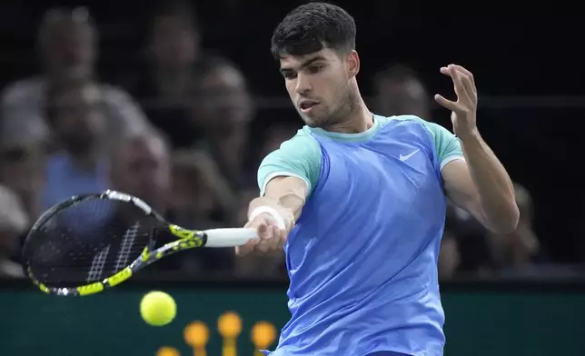 Spain's Carlos Alcaraz slams a forehand to France's Ugo Humbert during their third round match of the Paris Masters tennis tournament at the Accor Arena, Thursday, Oct. 31, 2024 in Paris. (AP Photo/Michel Euler)