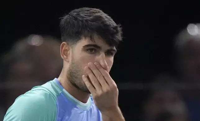 Spain's Carlos Alcaraz reacts as he plays France's Ugo Humbert during their third round match of the Paris Masters tennis tournament at the Accor Arena, Thursday, Oct. 31, 2024 in Paris. (AP Photo/Michel Euler)