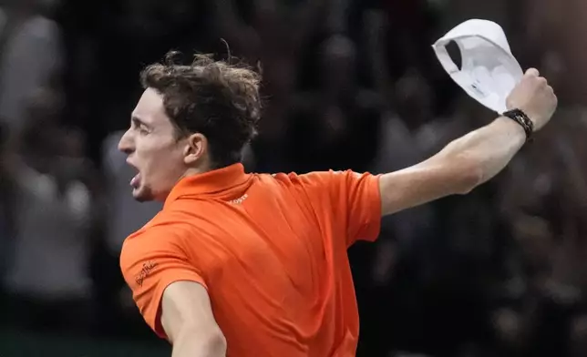 France's Ugo Humbert celebrates after defeating Spain's Carlos Alcaraz during their third round match at the Paris Masters tennis tournament at the Accor Arena, Thursday, Oct. 31, 2024 in Paris. (AP Photo/Michel Euler)