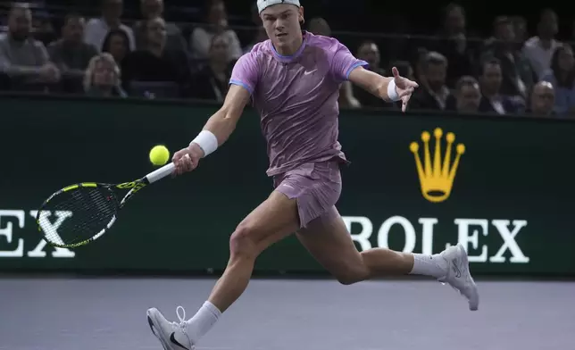 Denmark's Holger Rune returns to Germany's Alexander Zverev during the semifinal match of the Paris Masters tennis tournament at the Accor Arena on Saturday, Nov. 2, 2024, in Paris. (AP Photo/Thibault Camus)