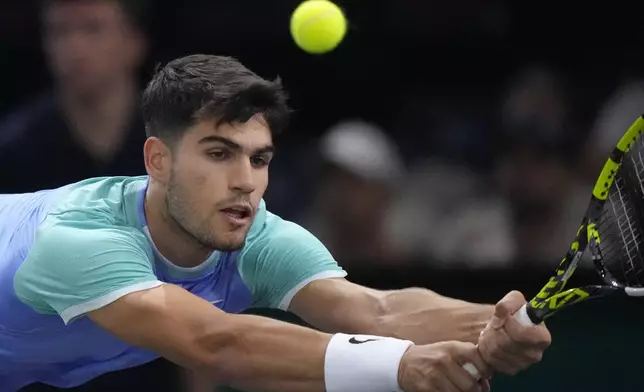 Spain's Carlos Alcaraz backhands to France's Ugo Humbert during their third round match of the Paris Masters tennis tournament at the Accor Arena, Thursday, Oct. 31, 2024 in Paris. (AP Photo/Michel Euler)