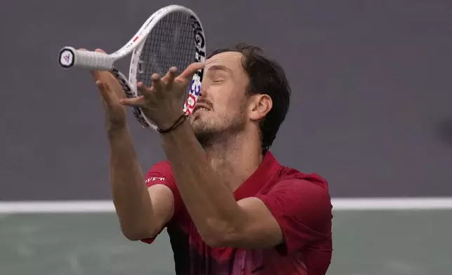 Russia's Daniil Medvedev throws his racket as he plays Alexei Popyrin, of Australia, during their second round match of the Paris Masters tennis tournament, Wednesday, Oct. 30, 2024 in Paris. (AP Photo/Michel Euler)