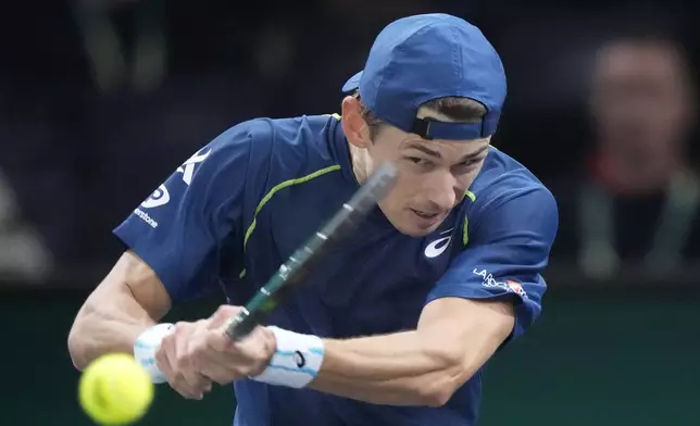 Alex de Minaur, of Australia, returns the ball to Denmark's Holger Rune during their quarterfinal match of the Paris Masters tennis tournament at the Accor Arena, Friday, Nov. 1, 2024 in Paris. (AP Photo/Michel Euler)