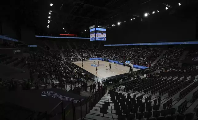 Spectators attend an NCAA college basketball game between UCLA and Louisville, Monday, Nov. 4, 2024, in Paris, France. (AP Photo/Aurelien Morissard)