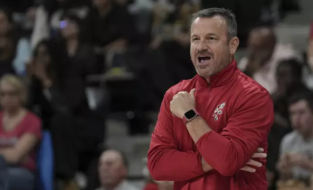 Louisville coach Jeff Walz watches during an NCAA college basketball game against UCLA Monday, Nov. 4, 2024, in Paris, France. (AP Photo/Aurelien Morissard)