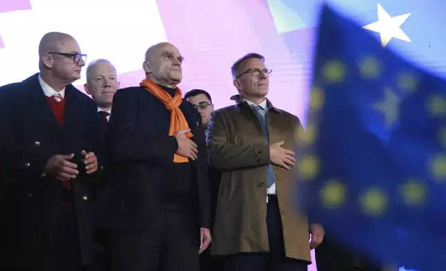 Front from left, Deputy Marshal of the Senate of Poland Michal Kaminski, member of French National Assembly Frederic Petit and member of Finnish Parliament Jukka Kopra attend a rally against alleged violations in a recent parliamentary election in Tbilisi, Georgia, Monday, Nov. 11, 2024. (AP Photo/Zurab Tsertsvadze)