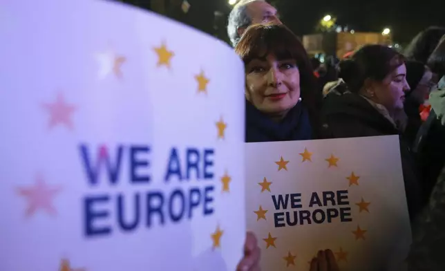 A woman holds a banner saying "We are Europe" during a protest against alleged violations in a recent parliamentary election in Tbilisi, Georgia, Monday, Nov. 11, 2024. (AP Photo/Zurab Tsertsvadze)