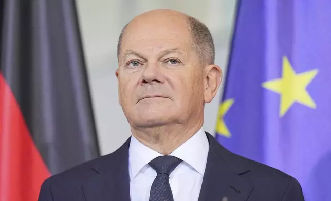 German Chancellor Olaf Scholz stands at the presentation of the annual report of the German Council of Economic Experts, in Berlin, Wednesday Nov. 13, 2024. (Michael Kappeler/dpa via AP)