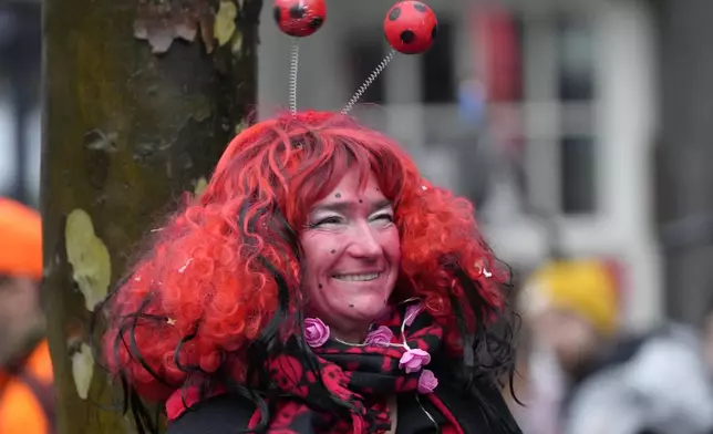 A costumed reveler smiles at the central Heumarkt while tens of thousands of carnival fools take to the streets of Cologne, Germany, on Monday, November 11, 2024, heralding the official start of the carnival season. (AP Photo/Martin Meissner)