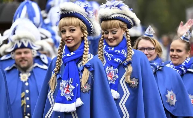 Carnival revellers celebrate the start of carnival on the market square in Duesseldorf, Germany, Monday Nov. 11, 2024. (Federico Gambarini/dpa via AP)