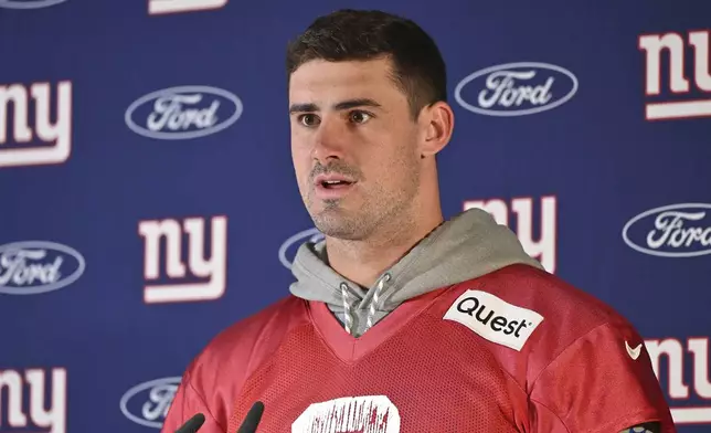 New York Giants quarterback Daniel Jones (8) attends a news conference after a practice session in Munich, Germany, Friday, Nov. 8, 2024. The New York Giants are set to play the Carolina Panthers in an NFL game at the Allianz Arena in Munich on Sunday. (AP Photo/Lennart Preiss)