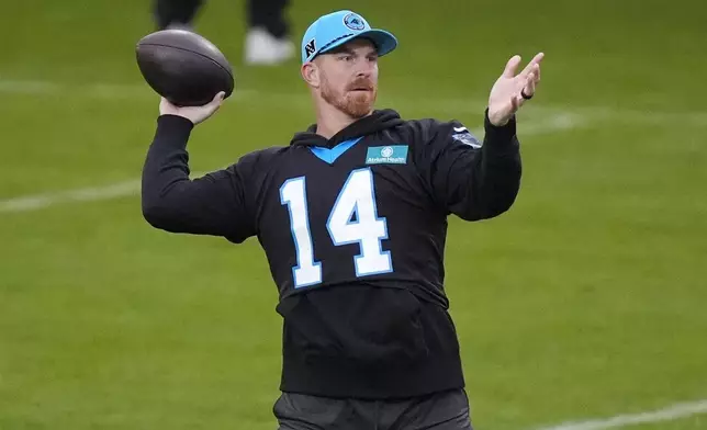 Carolina Panthers quarterback Andy Dalton (14) throws a ball during practice session in Munich, Germany, Friday, Nov. 8, 2024. The Carolina Panthers are set to play the New York Giants in an NFL game at the Allianz Arena in Munich on Sunday Nov. 10. (AP Photo/Matthias Schrader)
