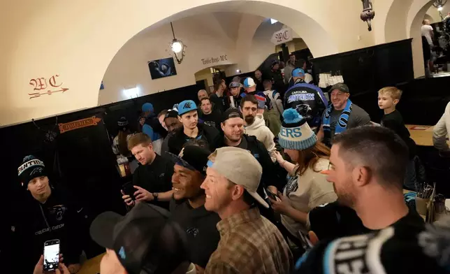 Carolina Panthers supporters enjoy the day inside the traditional 'Augustiner' beer house in Munich, Germany, Saturday, Nov. 9, 2024 ahead of the NFL match between the Carolina Panthers and the New York Giants in Munich on Sunday. (AP Photo/Matthias Schrader)
