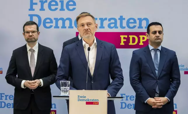 Christian Lindner, center, outgoing Federal Minister of Finance, speaks during a press conference at the FDP party headquarters, in Berlin, Thursday, Nov. 7, 2024. (Christoph Soeder/dpa via AP)