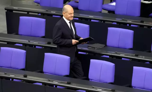 German Chancellor Olaf Scholz attends a plenary session in the German parliament Bundestag in Berlin, Germany, Wednesday, Nov. 13, 2024. (AP Photo/Markus Schreiber)