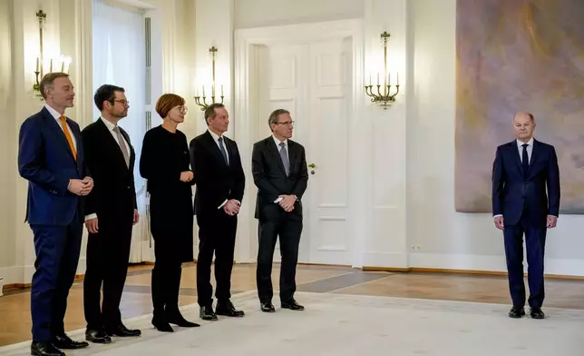 Christian Lindner , former Federal Minister of Finance, Marco Buschmann, former Federal Minister of Justice, Bettina Stark-Watzinger former Federal Minister of Education and Research, Volker Wissing, Federal Minister of Digital Affairs and Transport and Joerg Kukies (SPD), new Federal Minister of Finance, from left, stand together, as German Chancellor Olaf Scholz, right, looks on in the Bellevue Palace in Berlin, Germany, Thursday, Nov.7, 2024. (AP Photo/Ebrahim Noroozi)