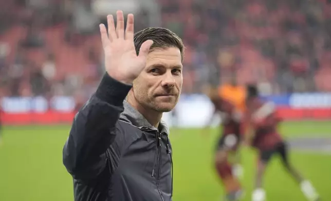 Leverkusen's head coach Xabi Alonso greets supporters ahead the German Bundesliga soccer match between Bayer Leverkusen and VfB Stuttgart at the BayArena in Leverkusen, Germany, Friday, Nov. 1, 2024. (AP Photo/Martin Meissner)