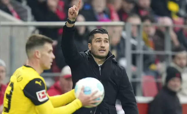 Dortmund head coach Nuri Sahin points during the German Bundesliga soccer match between 1. FSV Mainz 05 and Borussia Dortmund in Mainz, Germany, Saturday, Nov. 9, 2024. (Thomas Frey/dpa via AP)