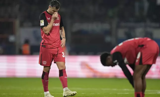 Leverkusen's Granit Xhaka stands dejected after the German Bundesliga soccer match between VfL Bochum and Bayer Leverkusen in Bochum, Germany, Saturday, Nov. 9, 2024. (AP Photo/Martin Meissner)